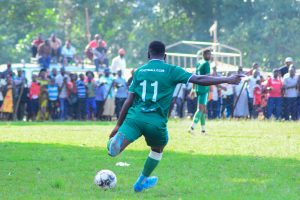 An Image of Ndagisiimana Karim kicking a ball.